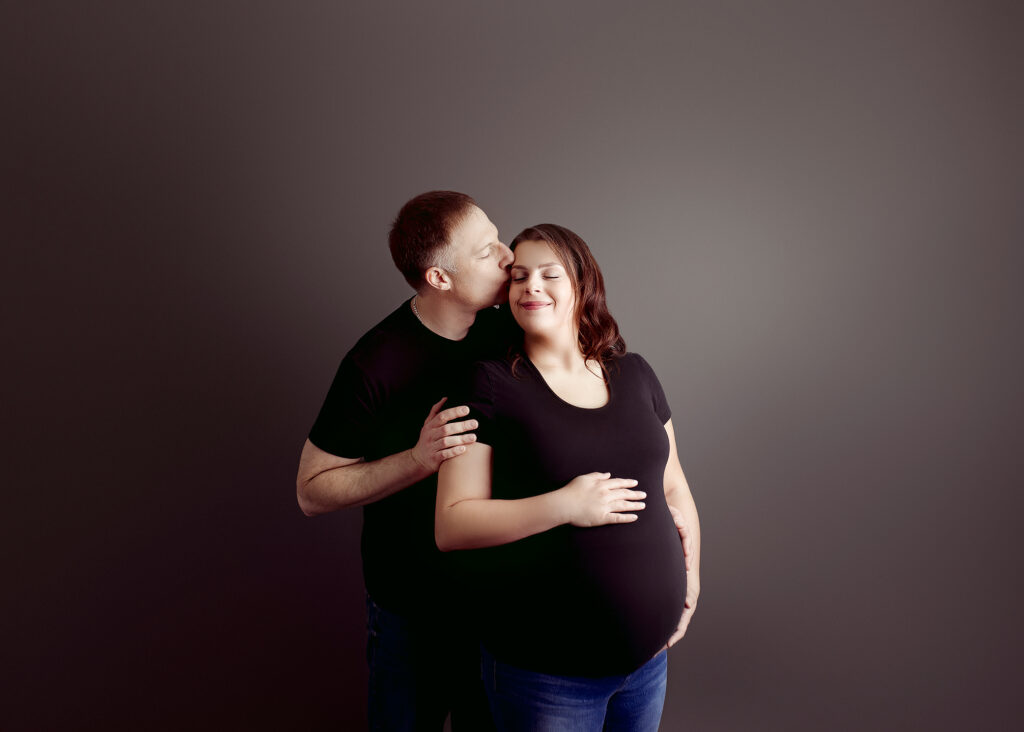 Studio Maternity Photography in Edmonton Couple posed romatically