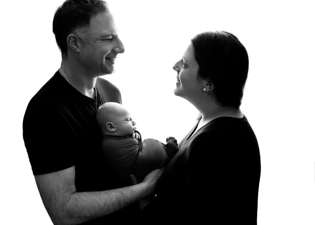 Studio Photography couple posed with newborn