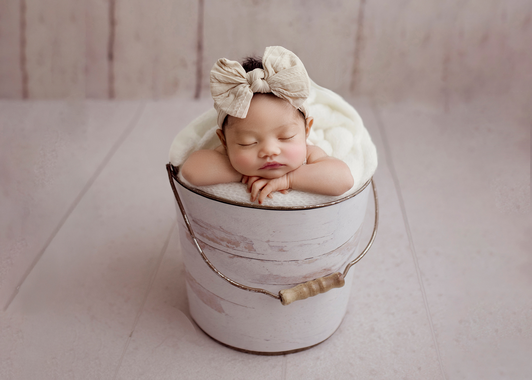 newborn posed in a bucket by Edmonton ewborn Photographer Kelsie Kelly Photographer