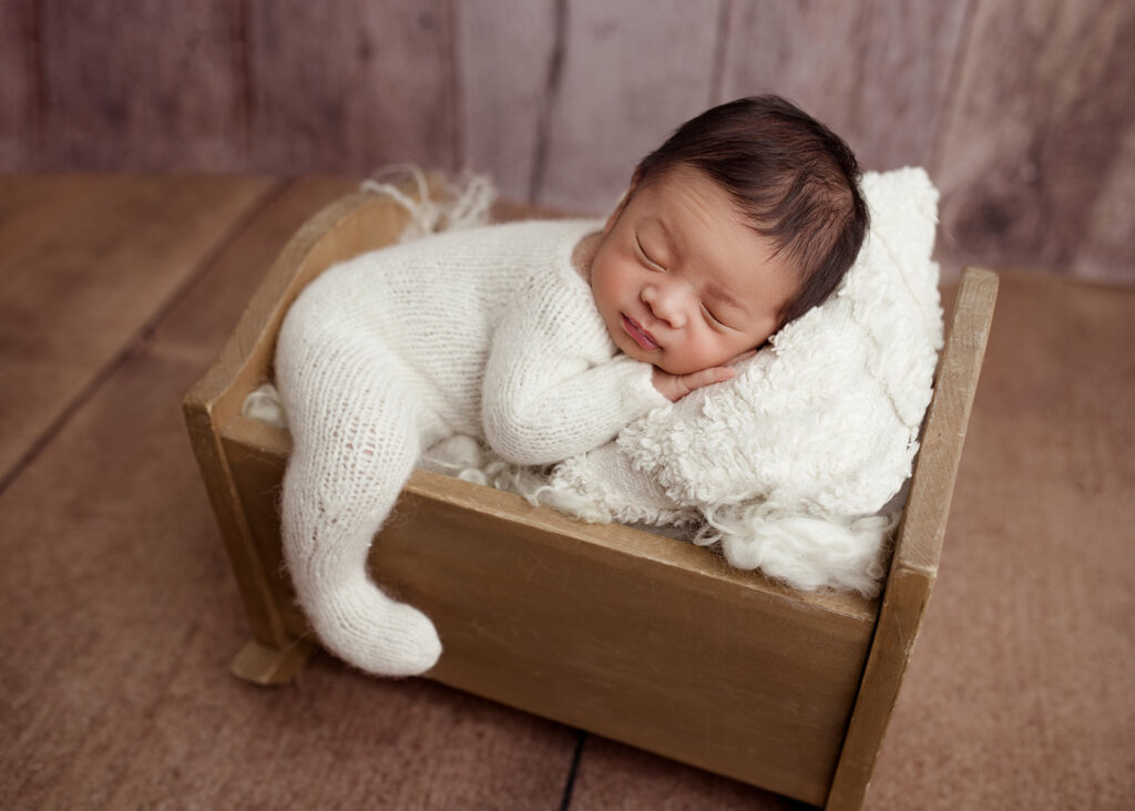 Newborn baby posed on little bed by Kelsie Kelly Photographer | Edmonton newborn photography studio