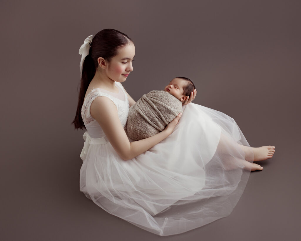 Sister holding newborn brother | Edmonton Newborn photography by Kelsie Kelly Photographer